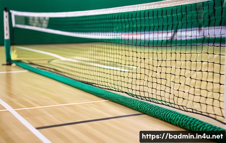 배드민턴 네트 규격과 높이 - A detailed close-up image of a professional badminton net setup on an indoor court, showing the net ...